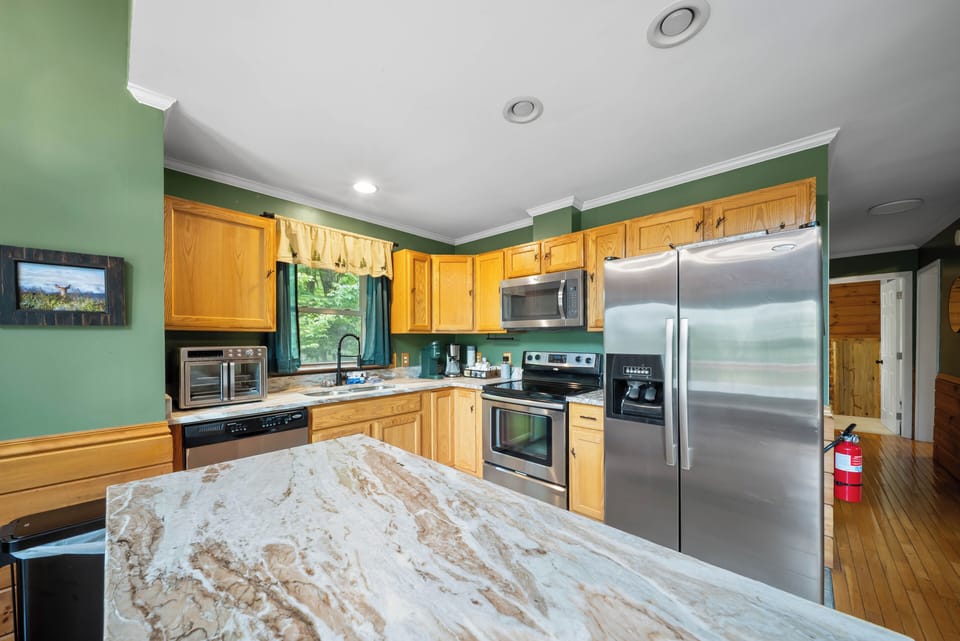 A full kitchen ready for the whole crew, with a generous marble island and stainless appliances at The Mountain Hearth Ii.