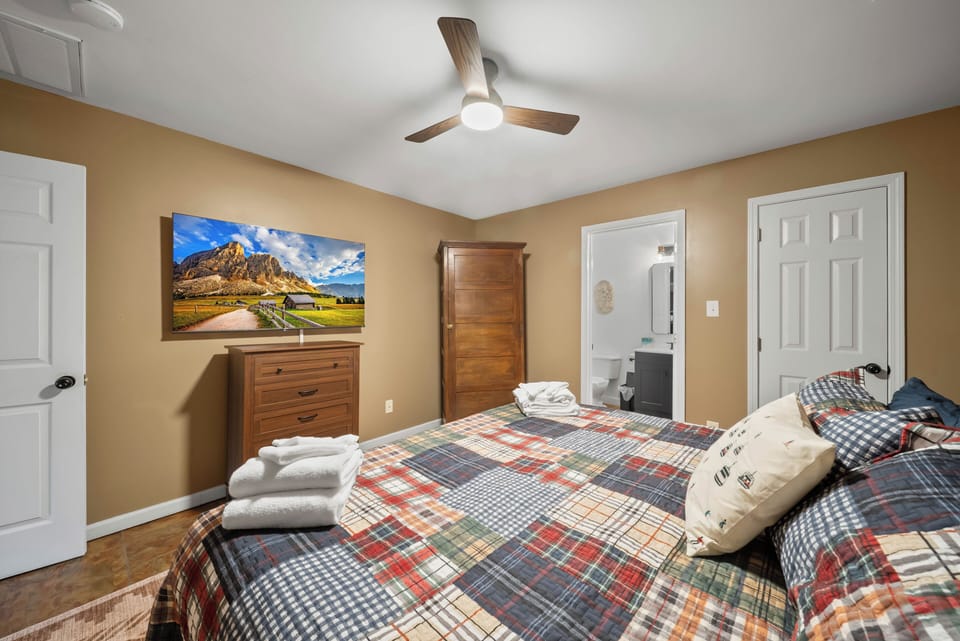 Fresh towels waiting, a cozy plaid quilt, and your own en-suite just steps away at The Mountain Hearth Ii.