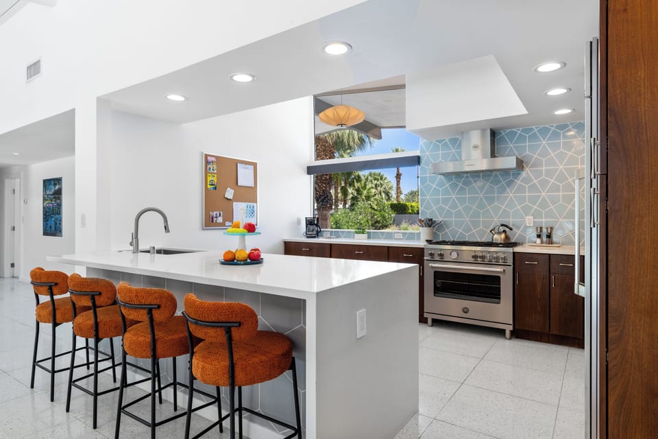 Large island, modern appliances, and large window to bring in more natural lighting.