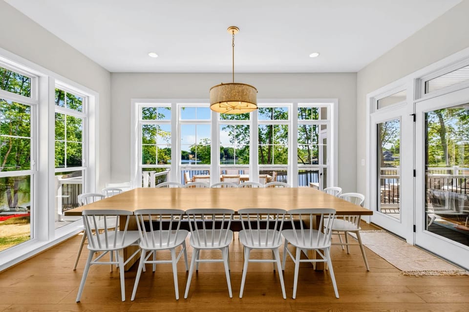 Dining Area - A custom extra-large table seats 14 under pendant lighting, set for group dinners.