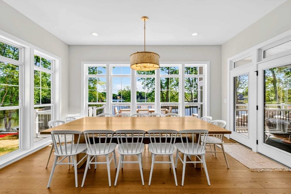 Dining Area - A custom extra-large table seats 14 under pendant lighting, set for group dinners.