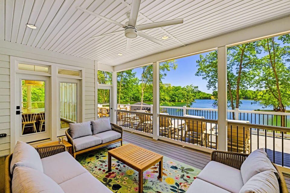 Screened Porch - Comfortable cushioned seating and a floral rug set the stage for relaxed afternoons overlooking the sparkling lake.
