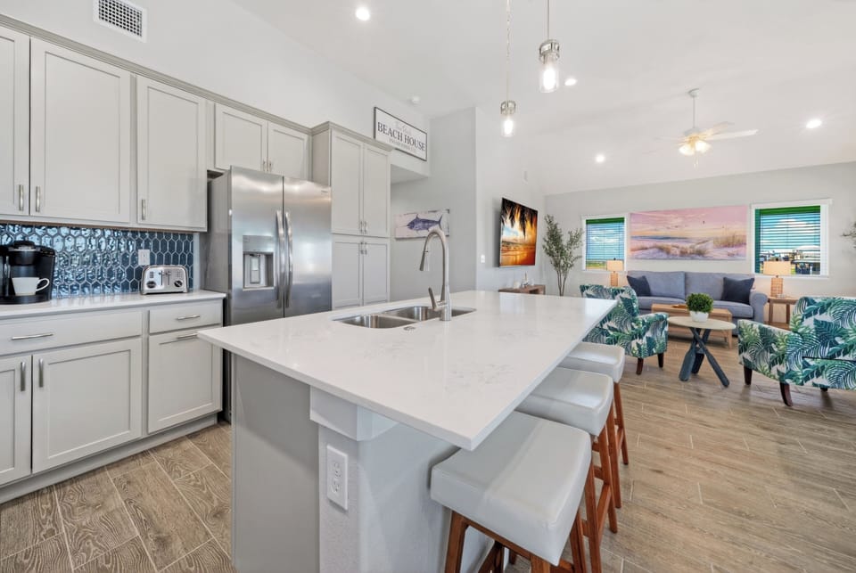 Gourmet kitchen island featuring sleek quartz countertops and under-counter barstool seating.