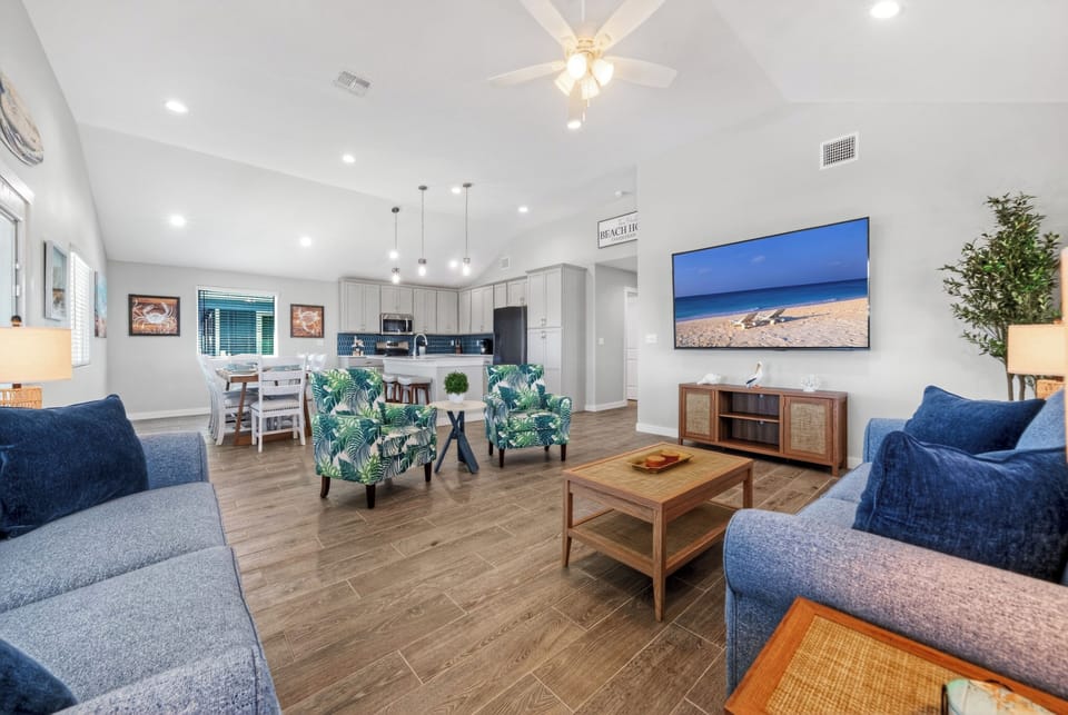 Expansive open-concept design showcasing a seamless flow from the fully equipped kitchen to the inviting main living area.