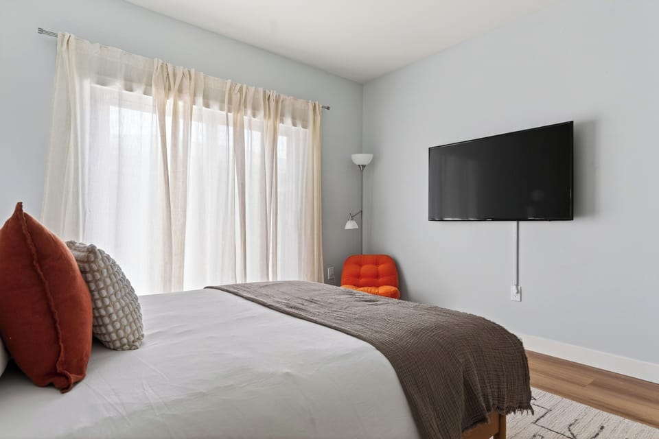 Bedroom 2 features a queen bed, TV and an ensuite bathroom.
