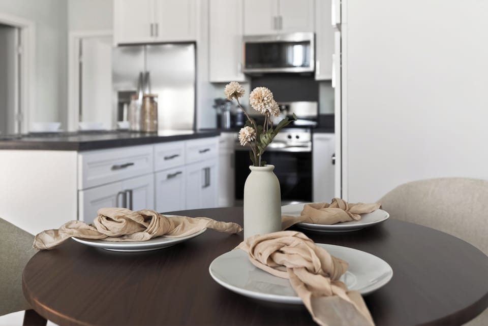 Cozy dining nook beside the bright modern kitchen, perfect for easy meals between beach outings.
