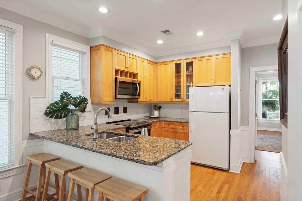 Stylish granite breakfast bar with seating, perfect for casual morning coffee or keeping the chef company.