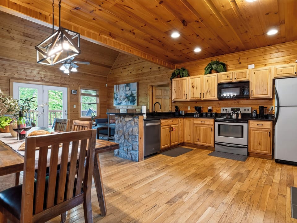 Warm wood interiors and an open-concept kitchen create the perfect setting for cozy mountain getaways.