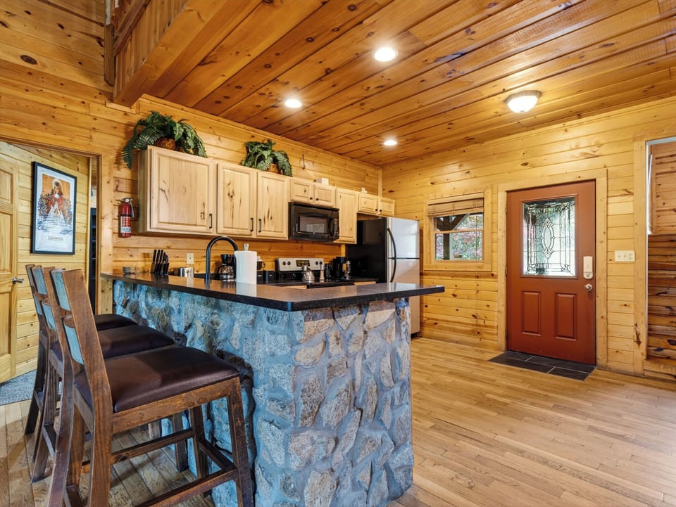 Fully equipped cabin kitchen with warm wood finishes and everything you need for group meals and mountain mornings.
