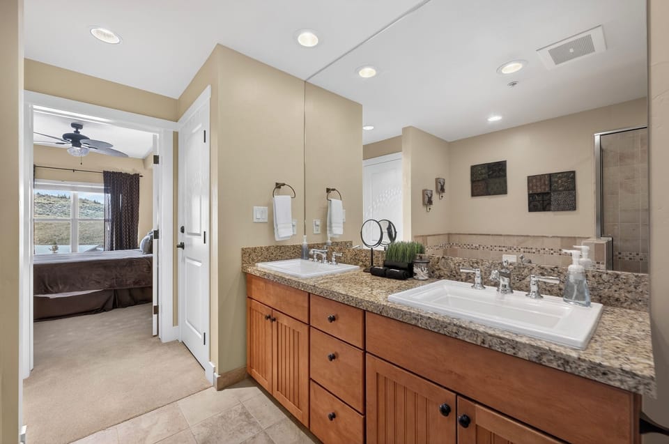 Master suite bath with double vanity, soaking tub, and shower