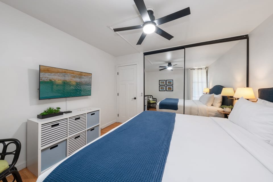 Comfortable king bedroom with storage, TV, and a clean layout.