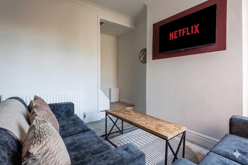 Comfortable seating, wall mounted TV and practical furnishings come together in this inviting living room. The open feel and relaxed setup create an easy space for spending time indoors during your stay.