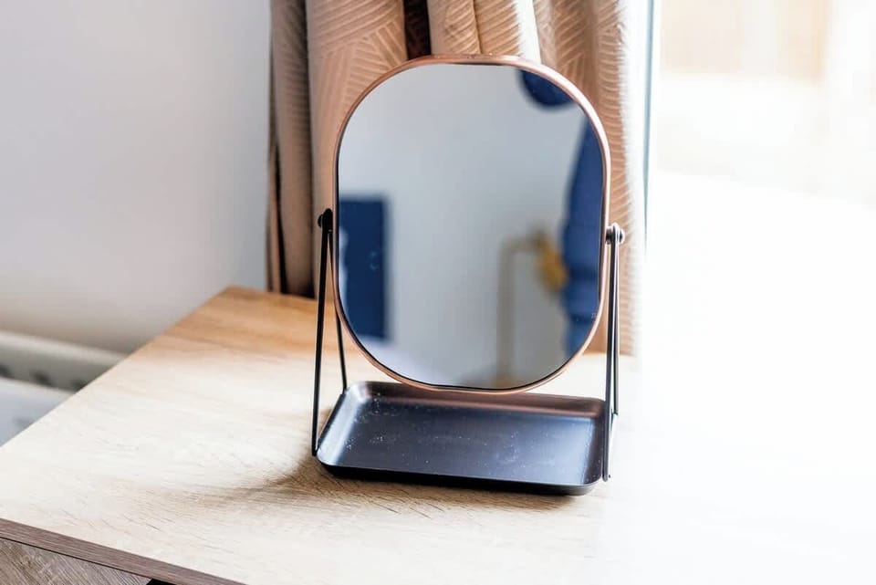 Useful bedside storage and a mirror add everyday convenience to this comfortable bedroom. The practical features and relaxed atmosphere help create an easy and enjoyable stay experience.