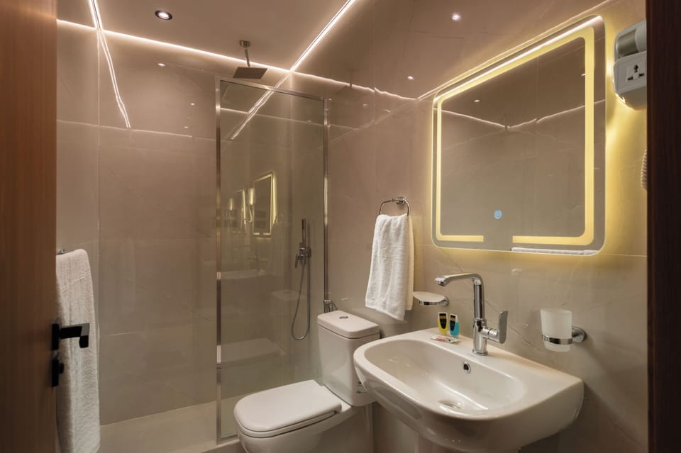 Separate tub and shower, hair dryer, slippers, towels