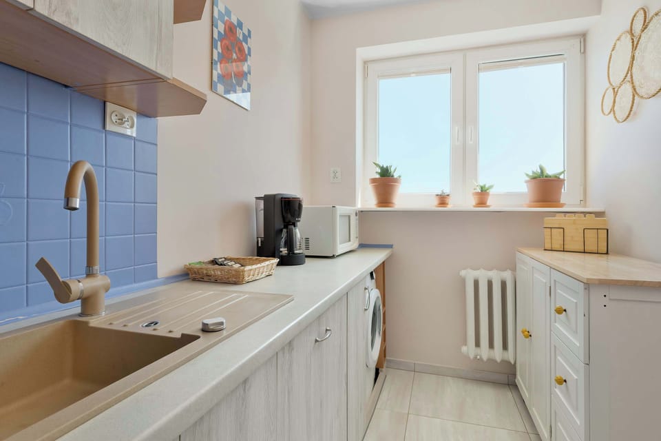 The sleek design of the kitchenette blending seamlessly with the living area.