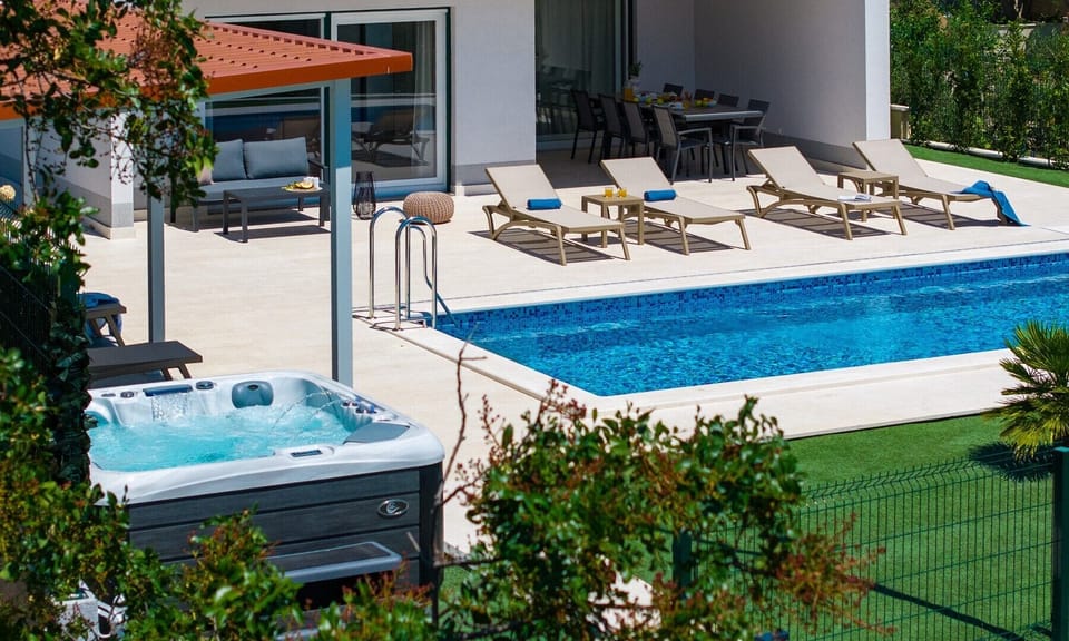 The outdoor space is truly a highlight, boasting a private and heated 32 sqm pool, perfect for leisurely swims under the sun