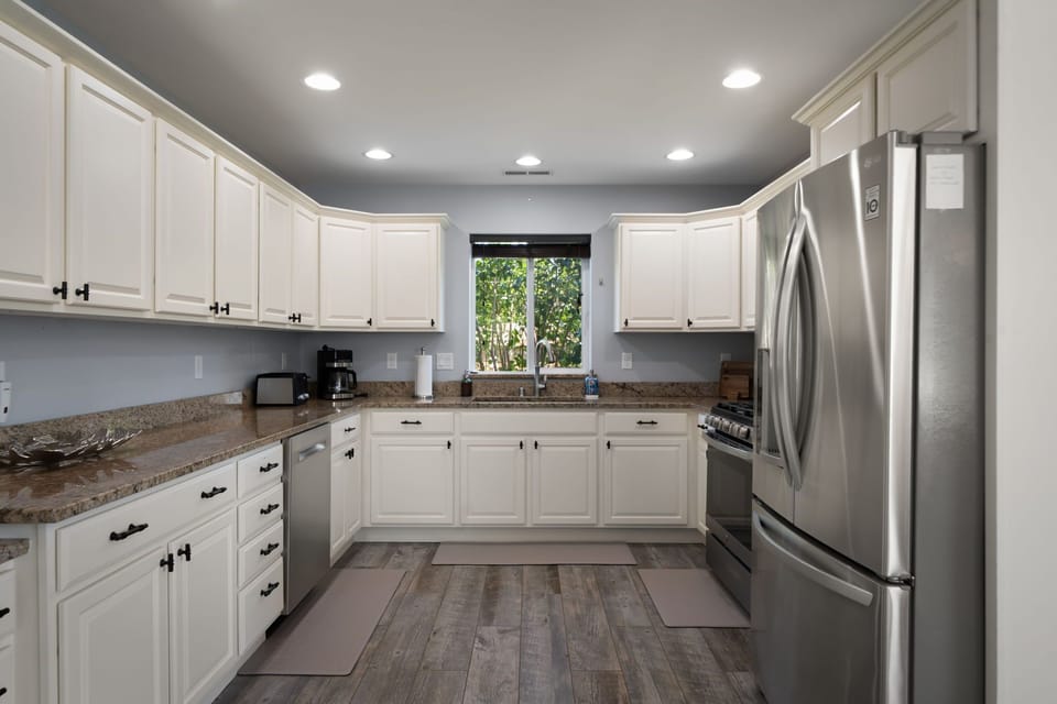 This oversized kitchen offers modern stainless steel appliances, abundant prep space, and a practical layout for extended stays.