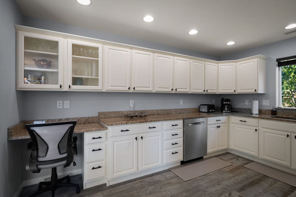 Thoughtfully designed for comfort and convenience, the spacious kitchen includes extensive cabinetry and ample room for cooking together.