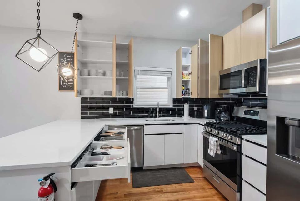 Cook with ease in a thoughtfully designed kitchen featuring a full-size stove, oven, microwave, and essential cookware.