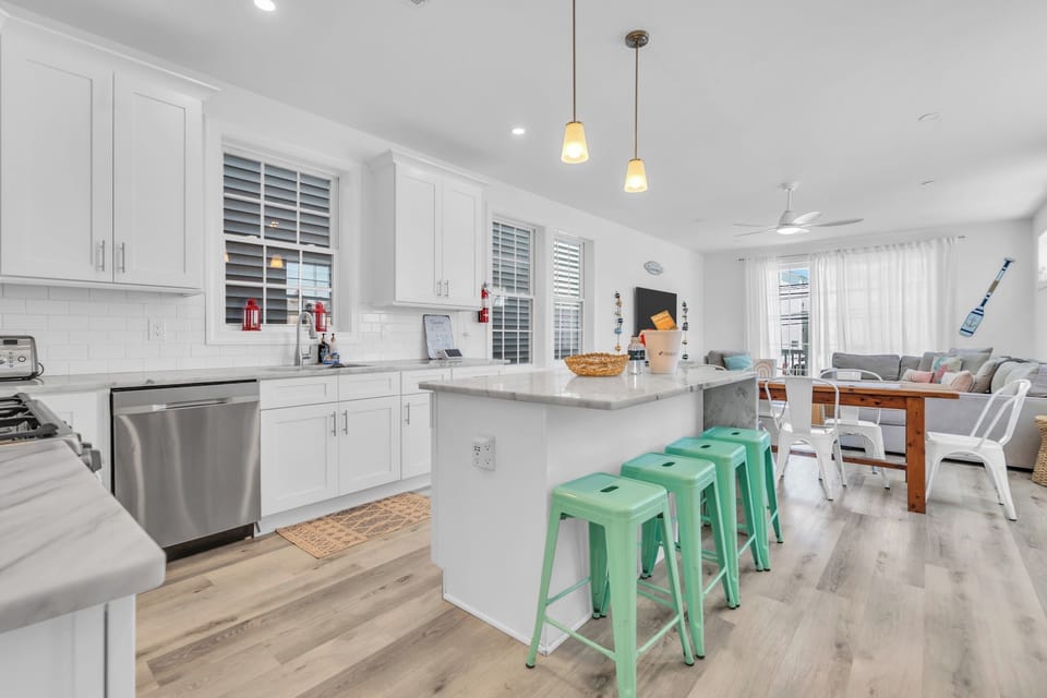 Bright open-concept kitchen with island seating and airy living space