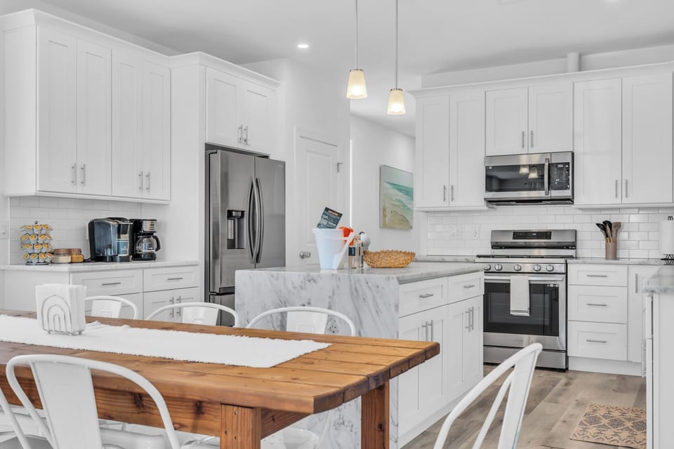 Bright modern kitchen with marble island and spacious dining table