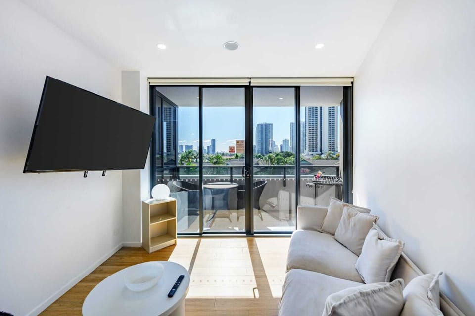 Relax in a sun-filled lounge with comfortable seating, TV, and stunning view