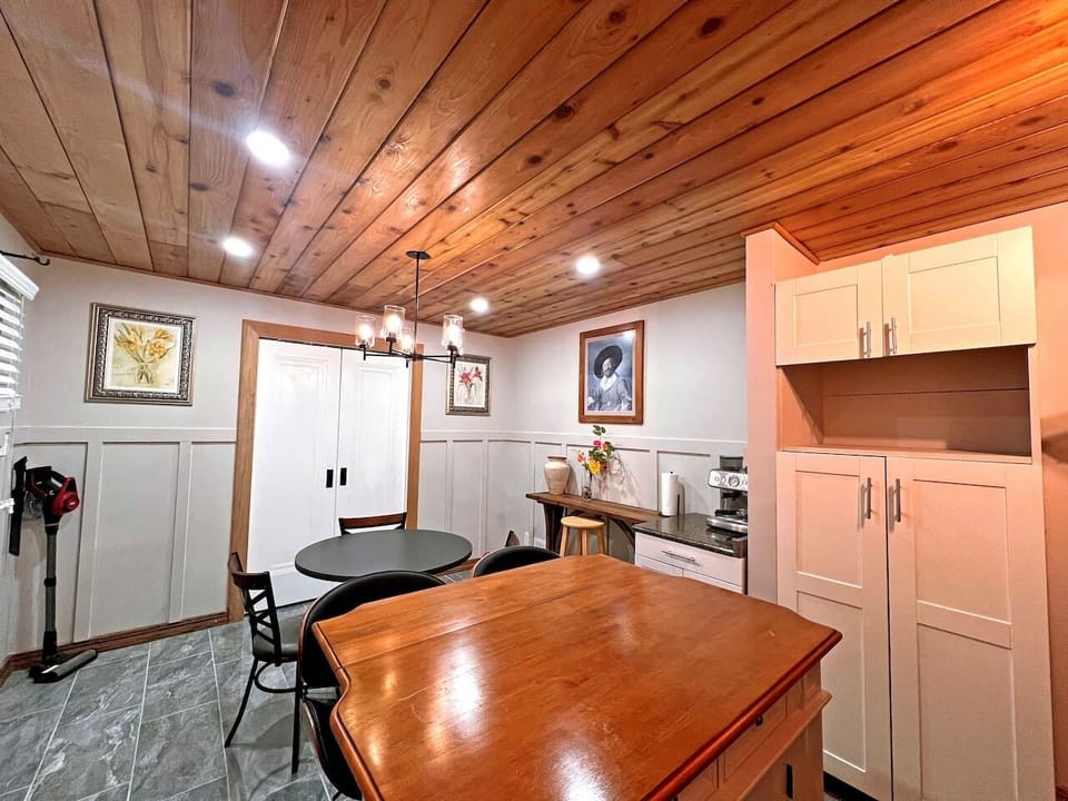 Full kitchen upstairs with an island and table