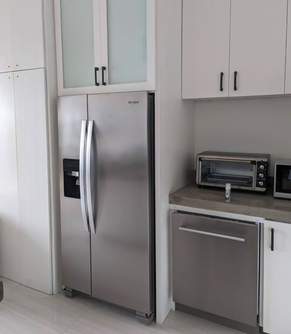 Modern kitchen with concrete counters and stainless appliances