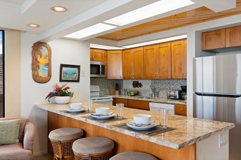 Kitchen with wood cabinets, bar seating, and dining essentials.