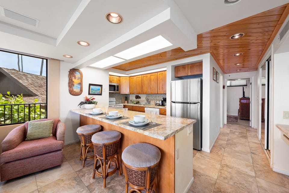 Bar seating connects kitchen to bright open living space.