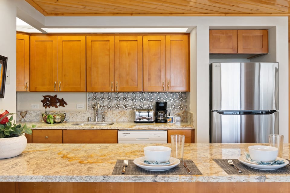 Kitchen features full appliances, cabinetry, and prep space.