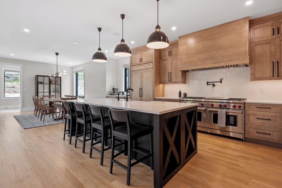 Chef's kitchen featuring a Wolf double-oven, range, and spacious island.
