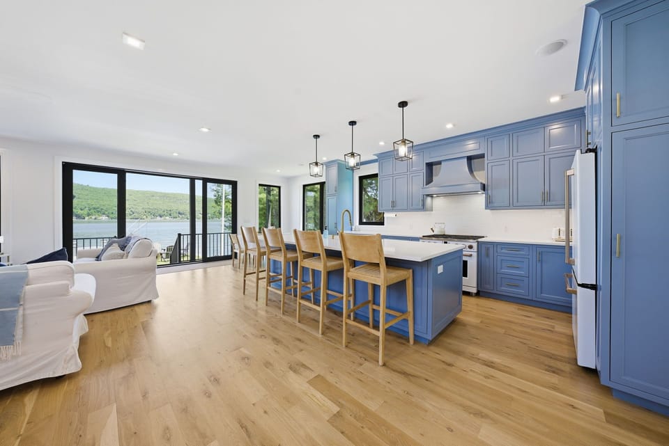 Bright chef’s kitchen and lakefront living space designed for gathering and entertaining.