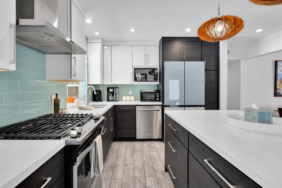 Fully equipped kitchen with gas range and sleek modern finishes