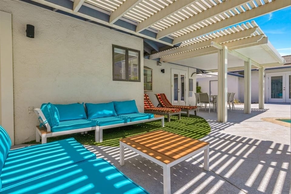 Shaded poolside lounge with comfortable seating and outdoor living