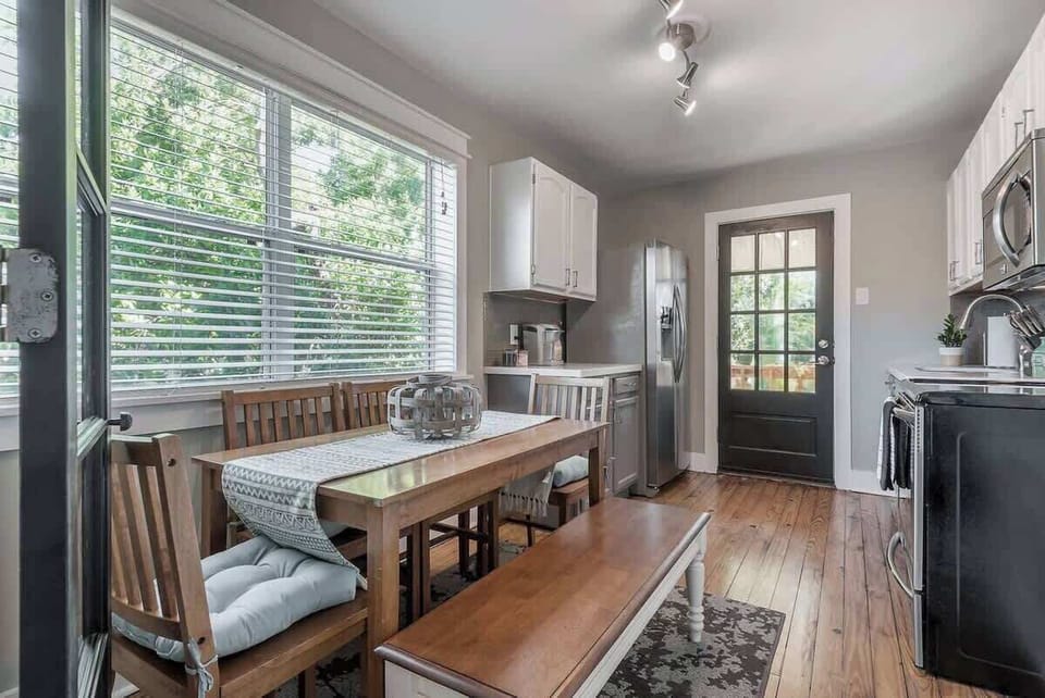 Dining Area: Bright and inviting space to enjoy meals, with a view of lush greenery!