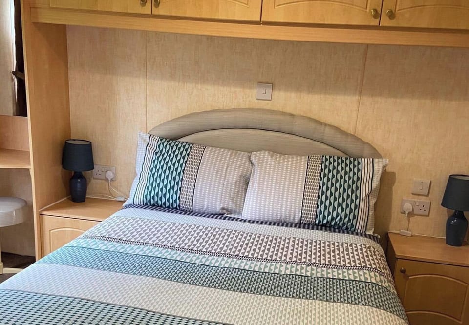 Modern and spacious master bedroom with a double bed, linen provided and ample storage.