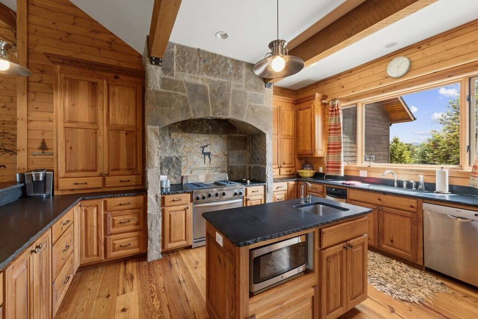 Fully equipped ranch kitchen with wood cabinetry, island, and scenic views