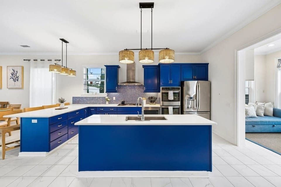 Bold Coastal Modern Kitchen

Custom-built kitchen with bold cobalt blue cabinetry, crisp white countertops, a spacious island, and woven rattan lighting, blending modern style with natural warmth.