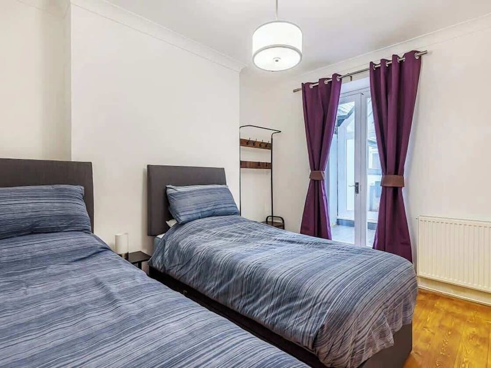 Second bedroom with two beds and patio
