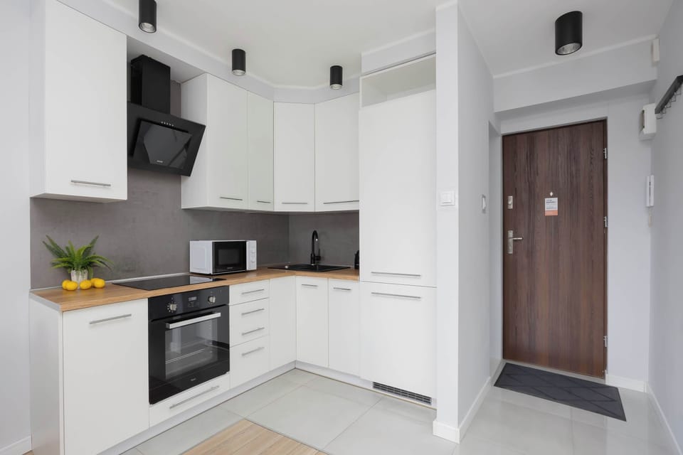 The sleek design of the kitchenette blending seamlessly with the living area.