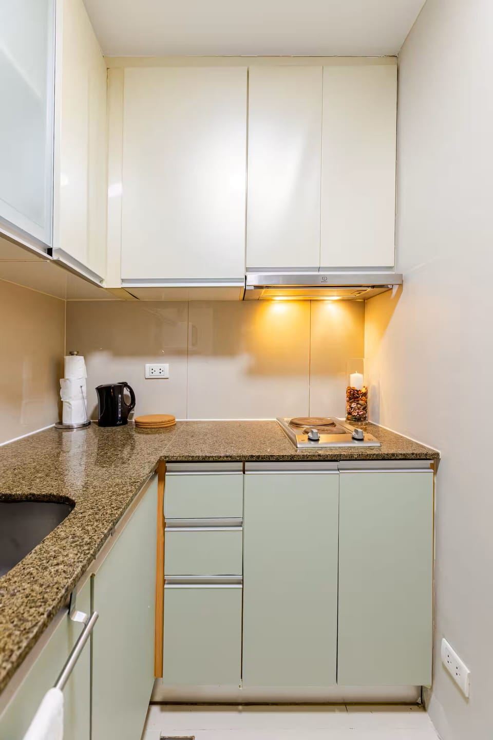 2-burner stove, exhaust hood, pots, pans, cookware, and fresh dish towels. 