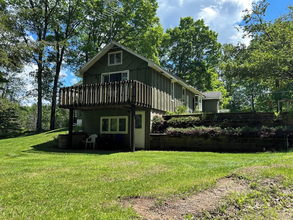 Side of house with balcony off main bedroom and patio off downstairs bedroom