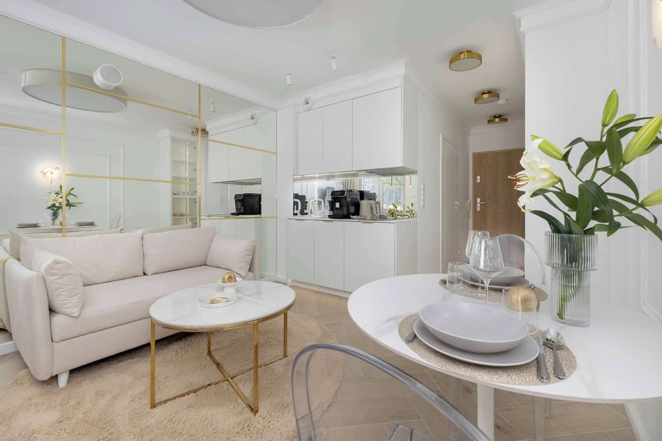 Open-plan living space with a cozy lounge area, dining table, and bright contemporary interior.