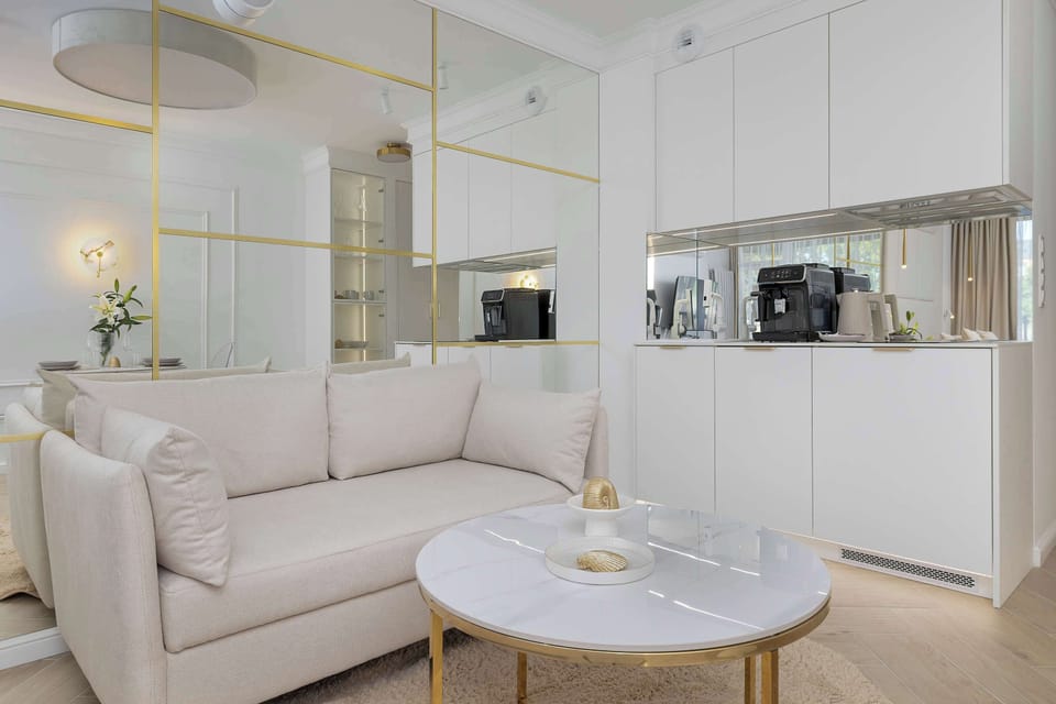 Bright living area with elegant furnishings and a fully equipped kitchenette.
