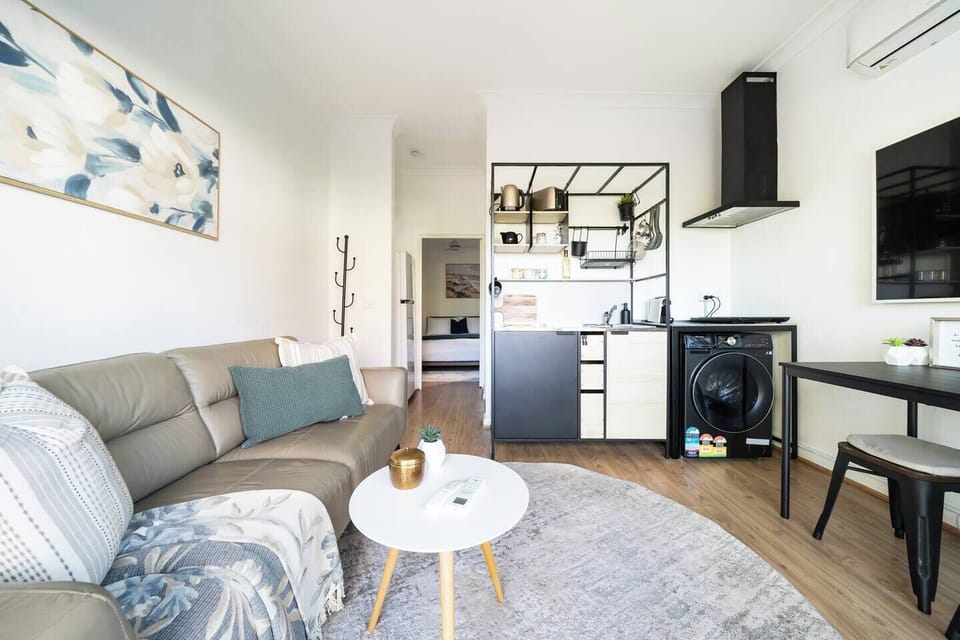 Relax into the comfortable living area after a day exploring nearby bushwalking trails, with soft natural light and a calm open-plan layout designed for easy stays.