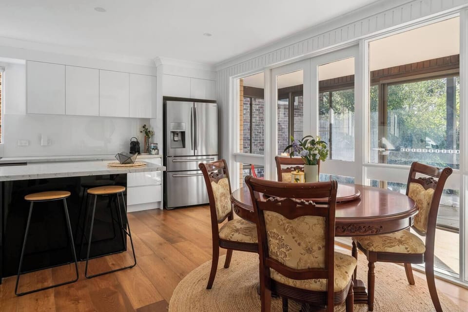 Enjoy long lunches and family dinners in the first dining area, where garden-facing windows bring soft natural light into the heart of the home.