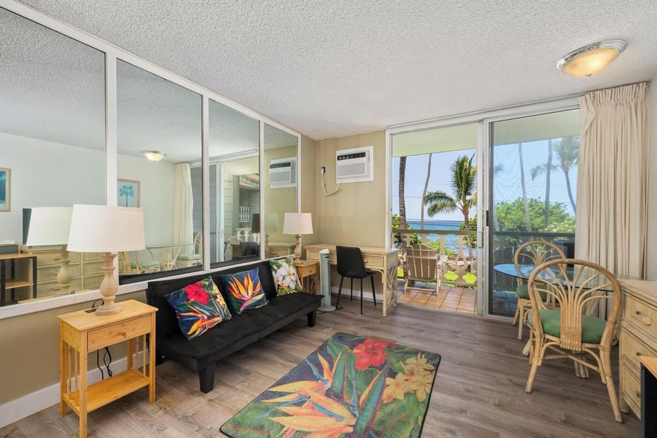 Your bright, island-inspired living space opens to a private lanai with palm trees and ocean views, creating the perfect Hawaiian retreat for relaxation.