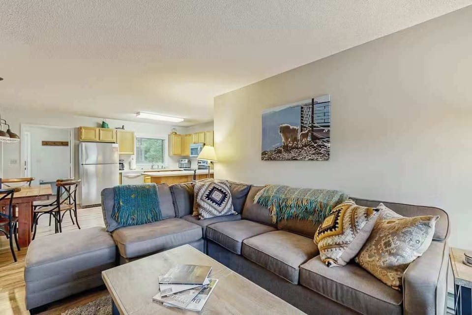 Living room: Electric fireplace, 55" Smart TV, sectional sofa, patio access