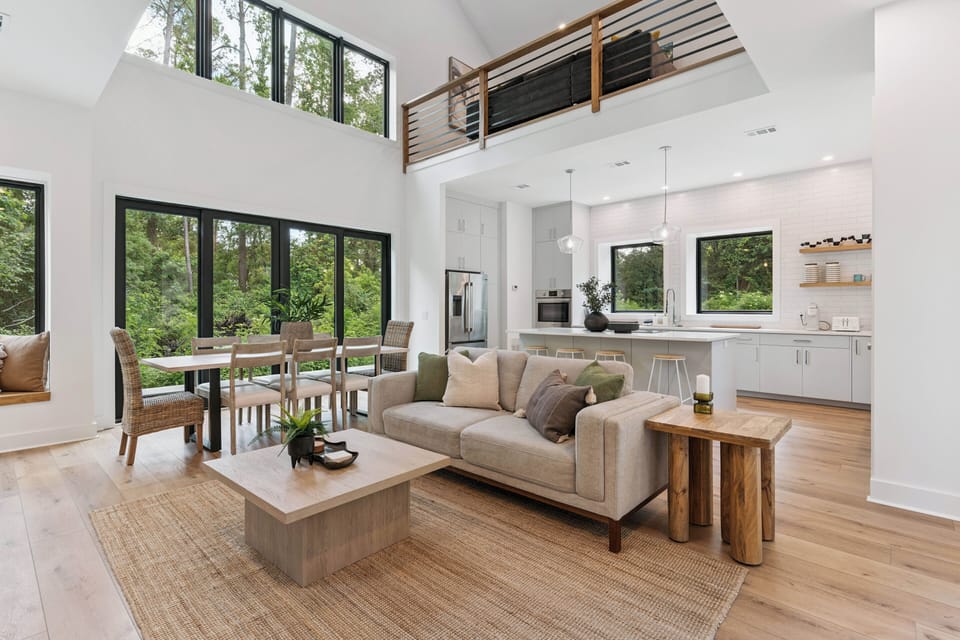 Relax in your bright, open living space where natural light pours through floor-to-ceiling windows. The high ceilings and loft create an airy retreat perfect for unwinding after exploring.